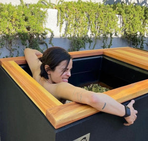 Woman cold plunging in RENU Therapy cold plunge tank